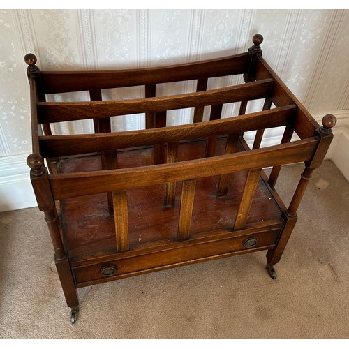 132 - A 20thC mahogany canterbury with drawer to base and brass castors. 53 h x 56 w x 36cm d.