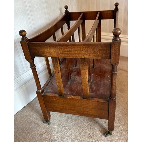 132 - A 20thC mahogany canterbury with drawer to base and brass castors. 53 h x 56 w x 36cm d.