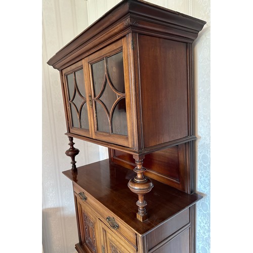 135 - An Edwardian mahogany cabinet, cupboard and single drawer to base, glazed doors to top with 4 compar... 