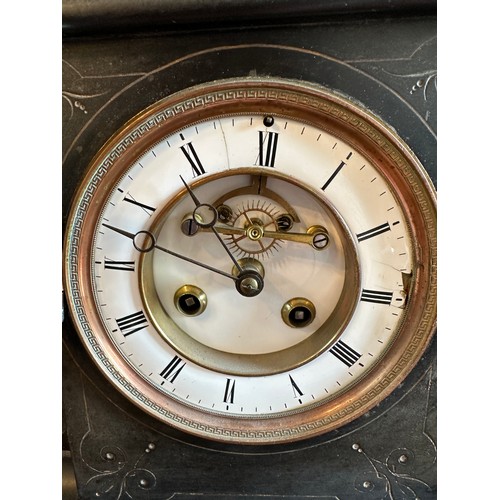 1038 - A 19thC black marble mantle clock with green marble pillars to both sides of white enamel face. 32 h... 