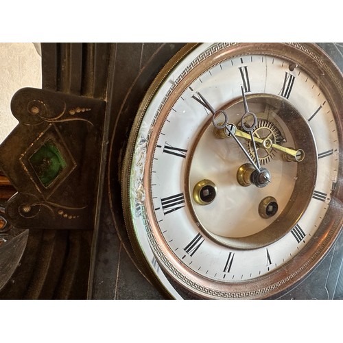 1038 - A 19thC black marble mantle clock with green marble pillars to both sides of white enamel face. 32 h... 