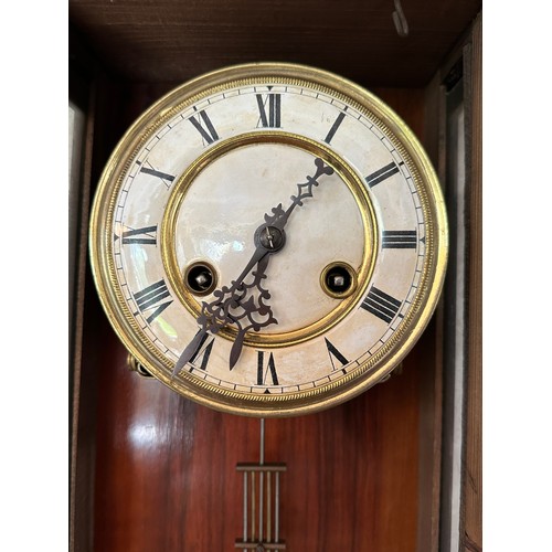 1040 - A mahogany wall clock with white enamel dial. 88 h x 37cm w approx.