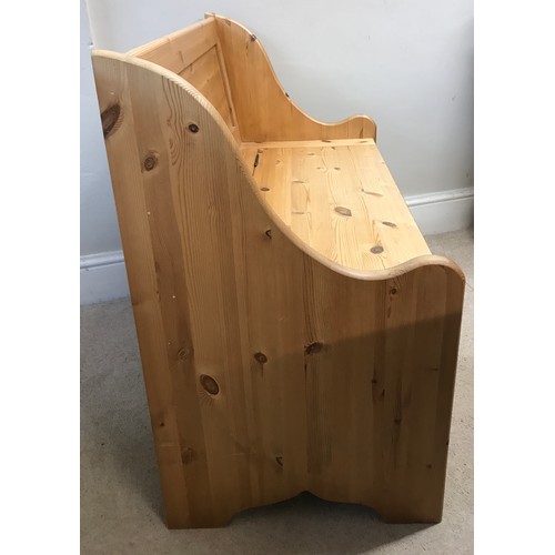 138 - A pine settle with a hinged seat storage space 100w x 85h x 51dn cm.