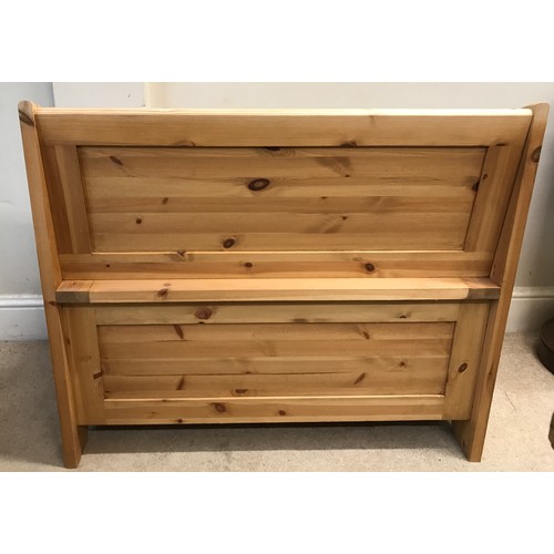 138 - A pine settle with a hinged seat storage space 100w x 85h x 51dn cm.