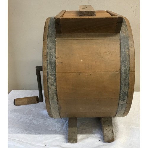 1228 - A 20thC wood and metal bound butter churn in shape of a barrel with winding handle stamped with R.C.... 