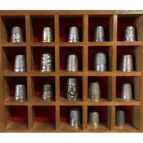 856 - A case holding 18 silver thimbles (first 4 rows) various hallmarks some saying sterling silver and 9... 