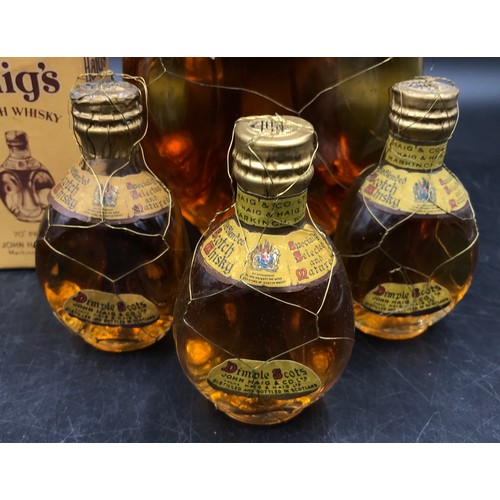 718 - One large and three miniature bottles of John Haig Dimple whisky. One miniature in a box.