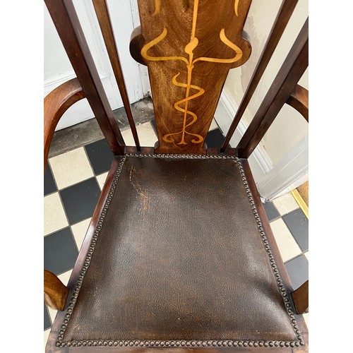 139 - A mahogany and inlaid Art Nouveau open armchair with leather seat. Height to back 115cm.