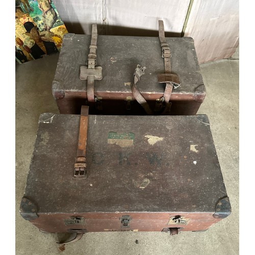 1237 - Two early 20thC travelling trunks with leather handles, corners and straps to one. Some luggage labe... 