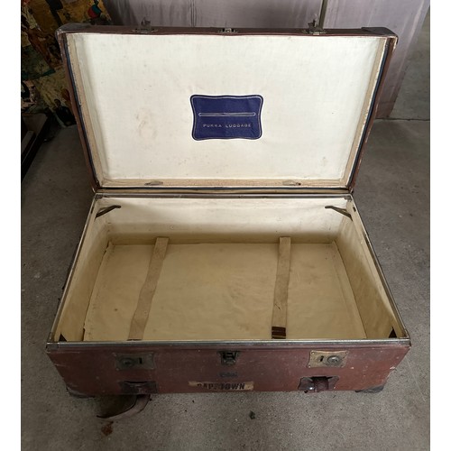 1237 - Two early 20thC travelling trunks with leather handles, corners and straps to one. Some luggage labe... 