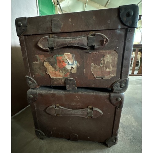 1237 - Two early 20thC travelling trunks with leather handles, corners and straps to one. Some luggage labe... 