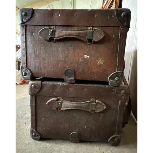 1237 - Two early 20thC travelling trunks with leather handles, corners and straps to one. Some luggage labe... 