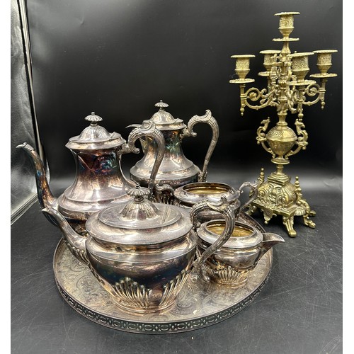 780 - A silverplated tea and coffee set with unassociated tray and a brass four branch candelabra.