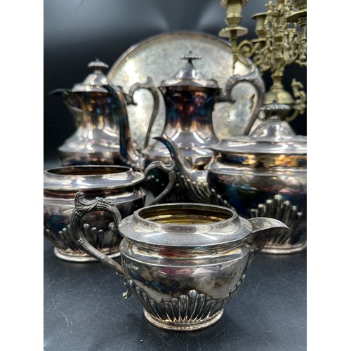 780 - A silverplated tea and coffee set with unassociated tray and a brass four branch candelabra.