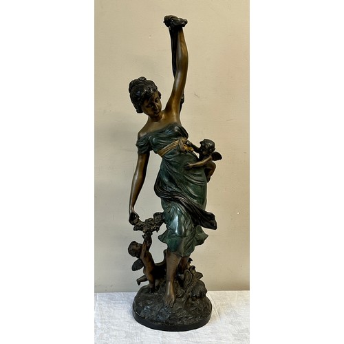 1244 - A heavy metal female figure with cherubs, 84cm h.