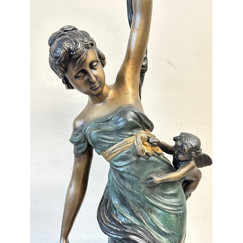 1244 - A heavy metal female figure with cherubs, 84cm h.