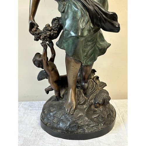 1244 - A heavy metal female figure with cherubs, 84cm h.