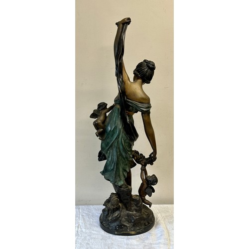 1244 - A heavy metal female figure with cherubs, 84cm h.