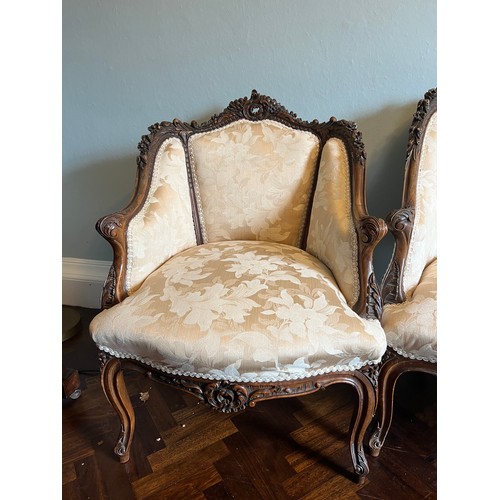 153 - A French cream upholstered sofa and two matching armchairs with decorative wood surround. Sofa 140 w... 