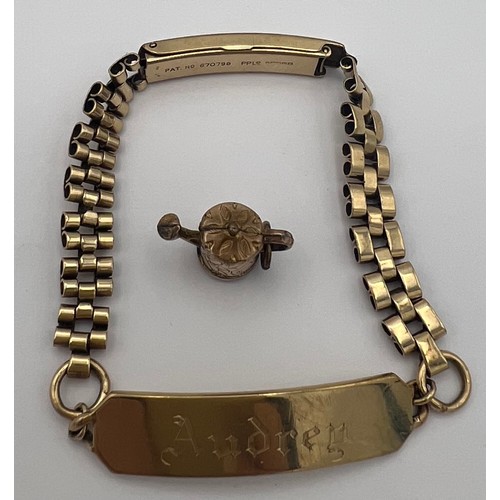 463 - A 9 carat gold identity bracelet together with an unmarked yellow metal watering can. Weight of brac... 