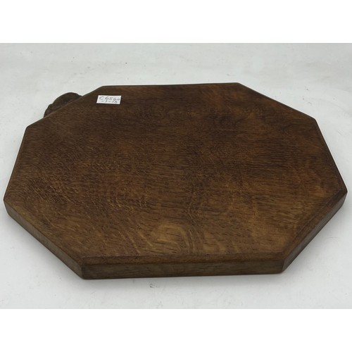 183 - An oak Peter Rabbitman Heap bread board. 31 x 25cm.