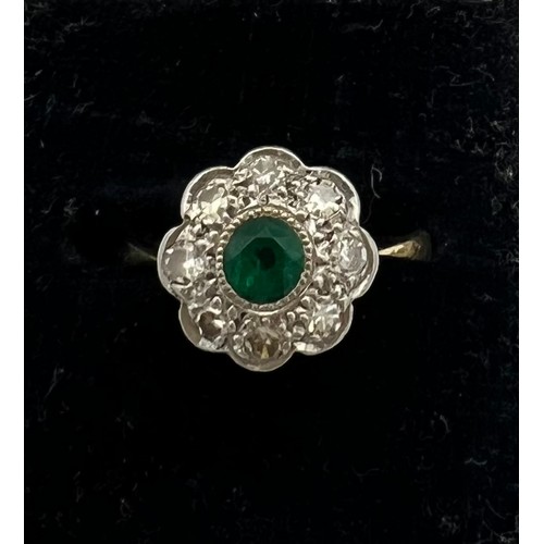 467 - An 18 carat and platinum emerald and diamond cluster ring. Size J. Weight 2.2gm.