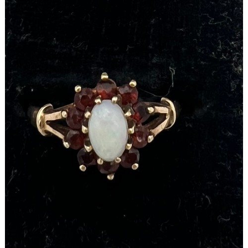 469 - A garnet and opal cluster ring set in 9 carat gold. Size K. Weight 1.6gm.