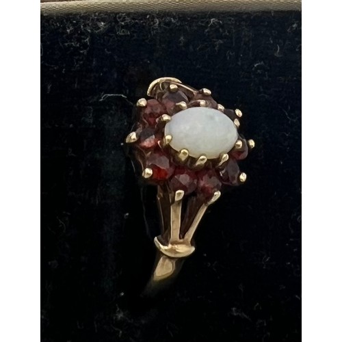 469 - A garnet and opal cluster ring set in 9 carat gold. Size K. Weight 1.6gm.