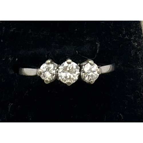 472 - A three stone diamond ring set in white metal. Size P, weight  1.9gm.