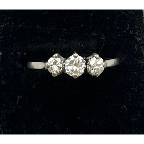 472 - A three stone diamond ring set in white metal. Size P, weight  1.9gm.