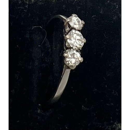 472 - A three stone diamond ring set in white metal. Size P, weight  1.9gm.