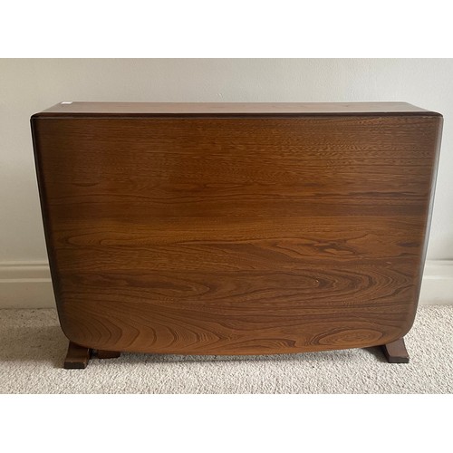 160 - An Ercol drop leaf occasional table. 102 l x 69 w x 45cm h. 16cm w closed.