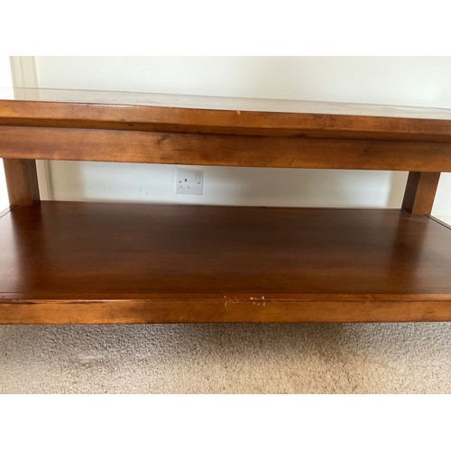 162 - A 20thC coffee table with shelf. 125 l x 60 w x 47cm h.