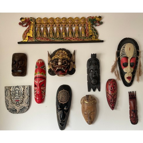 1254 - Eleven various wooden wall masks, dragon boat 96 w x 30cm h. One resin.