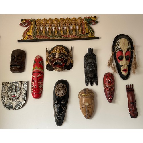 1254 - Eleven various wooden wall masks, dragon boat 96 w x 30cm h. One resin.