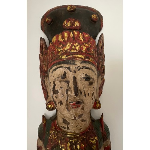 1255 - An Asian wooden wall mounted figure of a female. 150cm h.