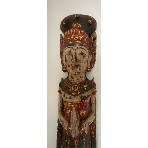 1255 - An Asian wooden wall mounted figure of a female. 150cm h.