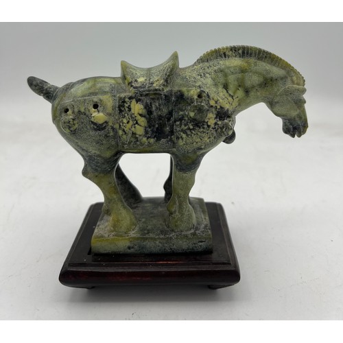 886 - A Chinese soapstone Tang horse, 11cm h on wooden stand.