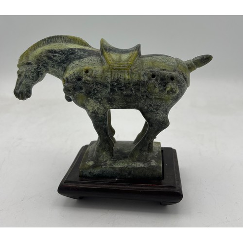 886 - A Chinese soapstone Tang horse, 11cm h on wooden stand.