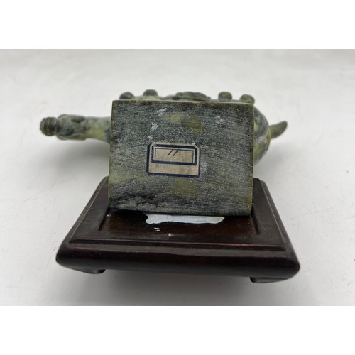 886 - A Chinese soapstone Tang horse, 11cm h on wooden stand.