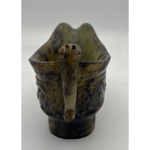 887 - A Chinese Qing spinach green and russet jade Archaistic pouring vessel Yi. 9cm h.