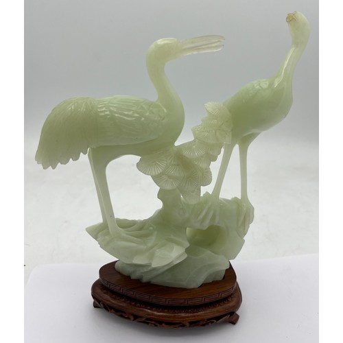 889 - A jade figure of two birds with wooden stand in original fitted case 19 cm h with another bird on ca... 