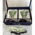 A pair of jade vases on wooden stands in original fitted box together with a figure of two birds on ... 
