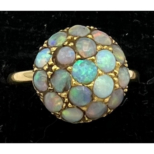 477 - A 18 carat gold ring set with opals. Size M. Weight 3.8gm.