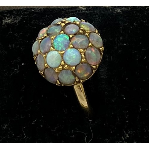 477 - A 18 carat gold ring set with opals. Size M. Weight 3.8gm.