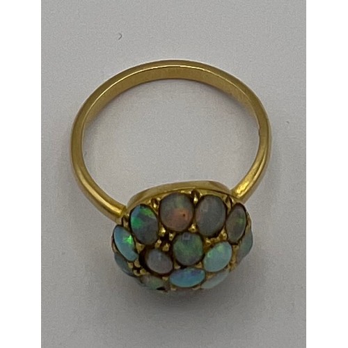 477 - A 18 carat gold ring set with opals. Size M. Weight 3.8gm.