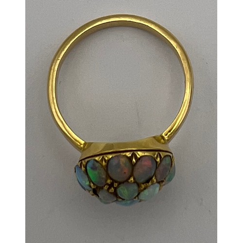 477 - A 18 carat gold ring set with opals. Size M. Weight 3.8gm.