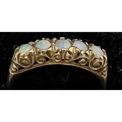 479 - A 9 carat gold ring set with five opals. Size N. Weight 2.2gm.