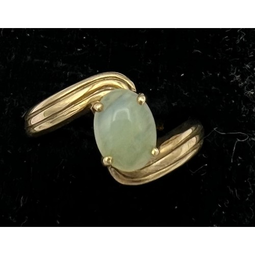 480 - A 9 carat gold ring set with pale green stone. Size N. Weight 2.7gm.