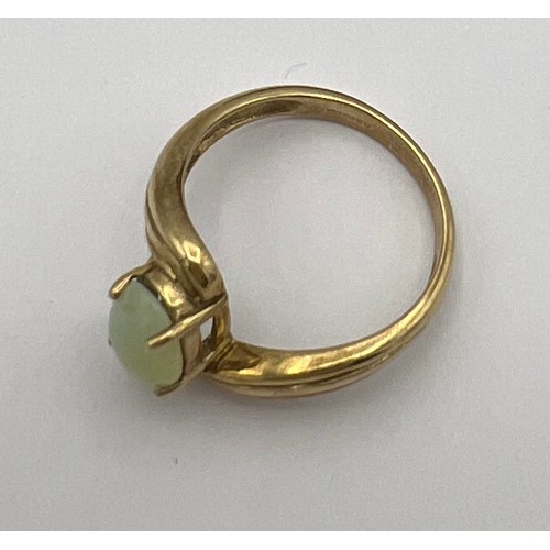 480 - A 9 carat gold ring set with pale green stone. Size N. Weight 2.7gm.